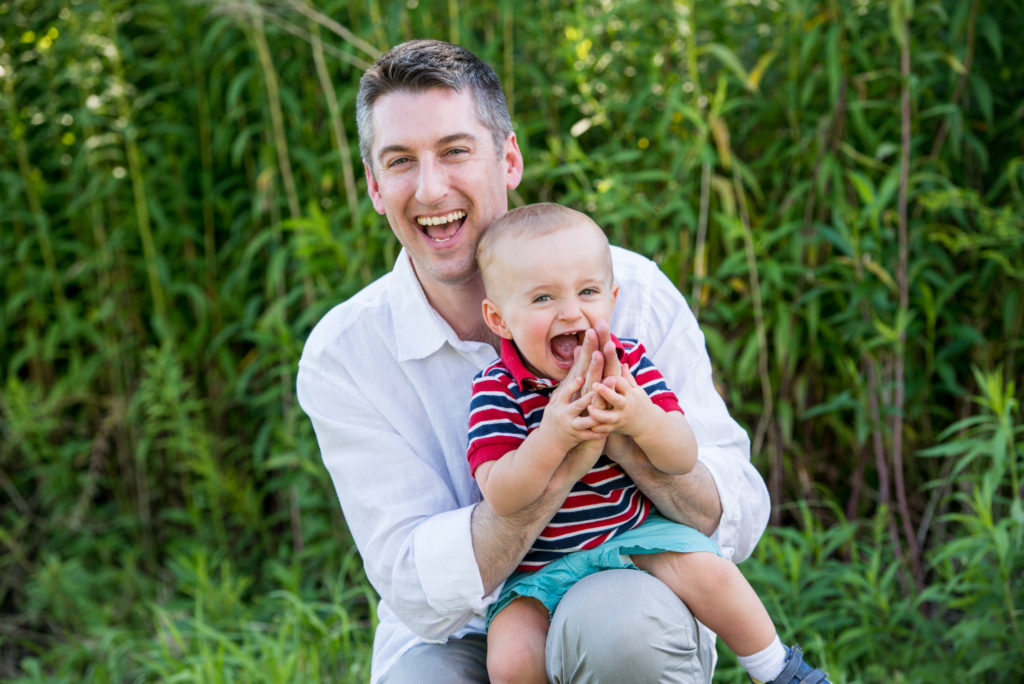 laughing dad with baby family portrait