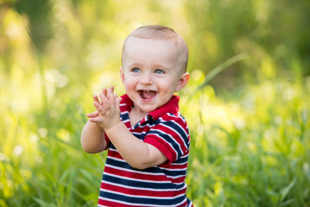 cute baby clapping family portrait outdoor
