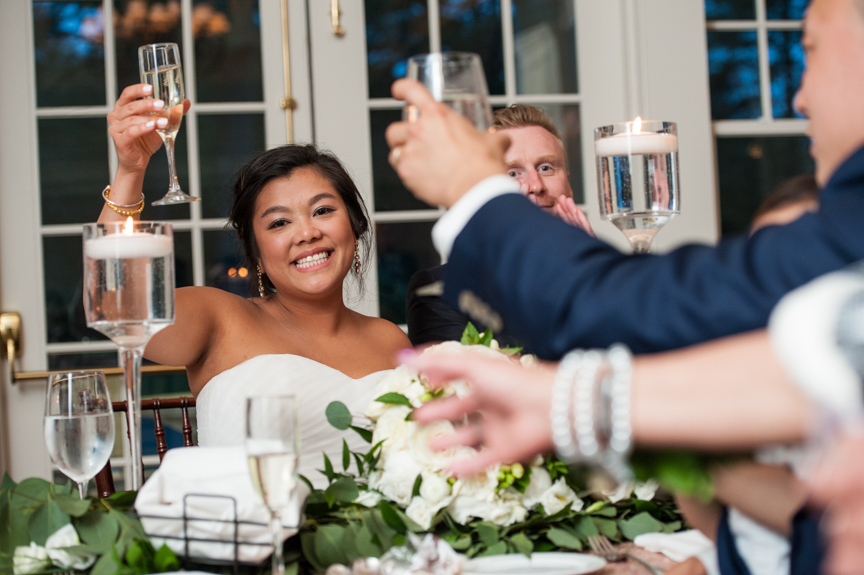 bride raises her glass in a toast