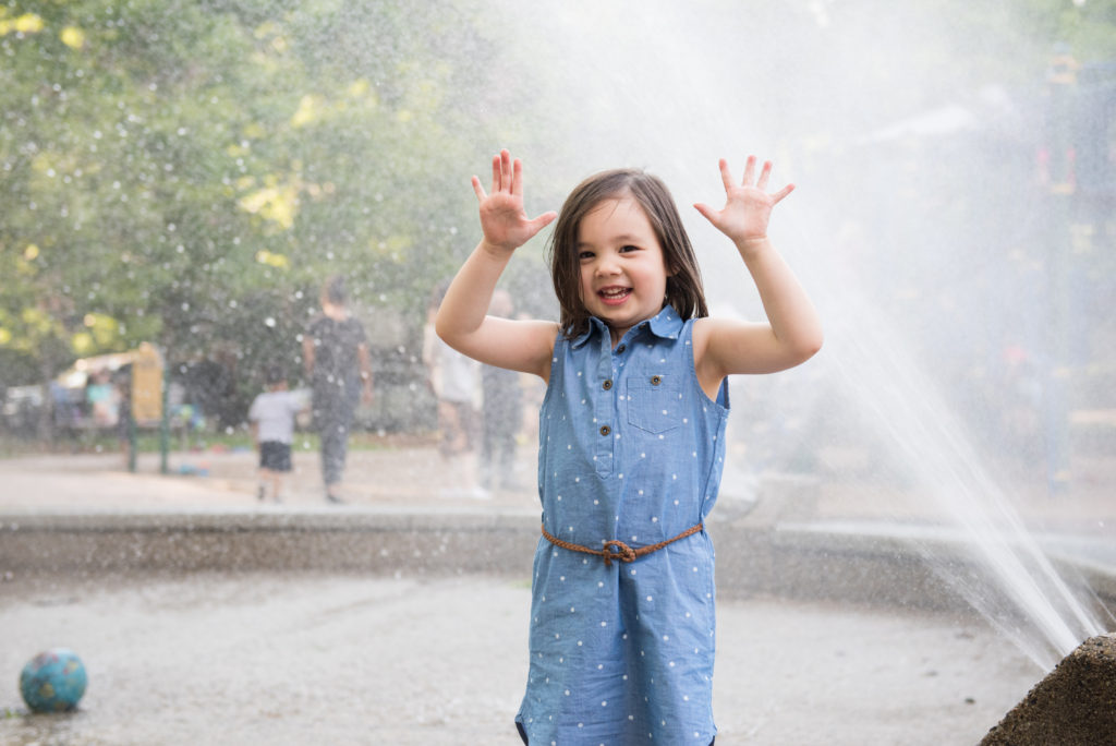 Fun family portraits brookline playground kid playing in fountain