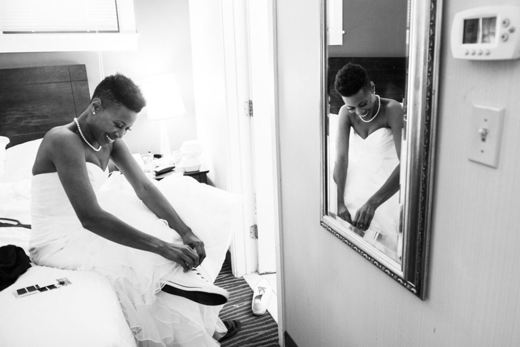 bride puts on sneakers before her wedding ceremony