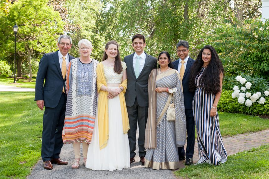 two families pose together for an outdoor formal family portrait before a wedding in Byfield Massachusetts