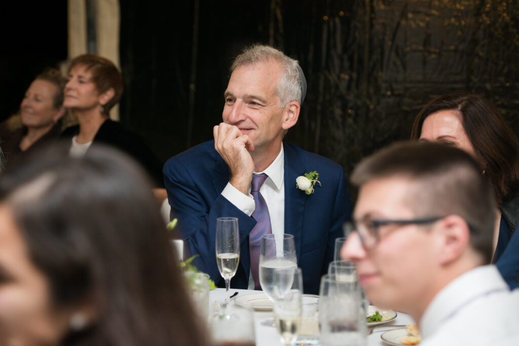 codman estate wedding man listens to a speech smiling