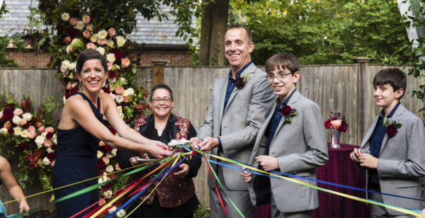 backyard wedding with children holding ribbons